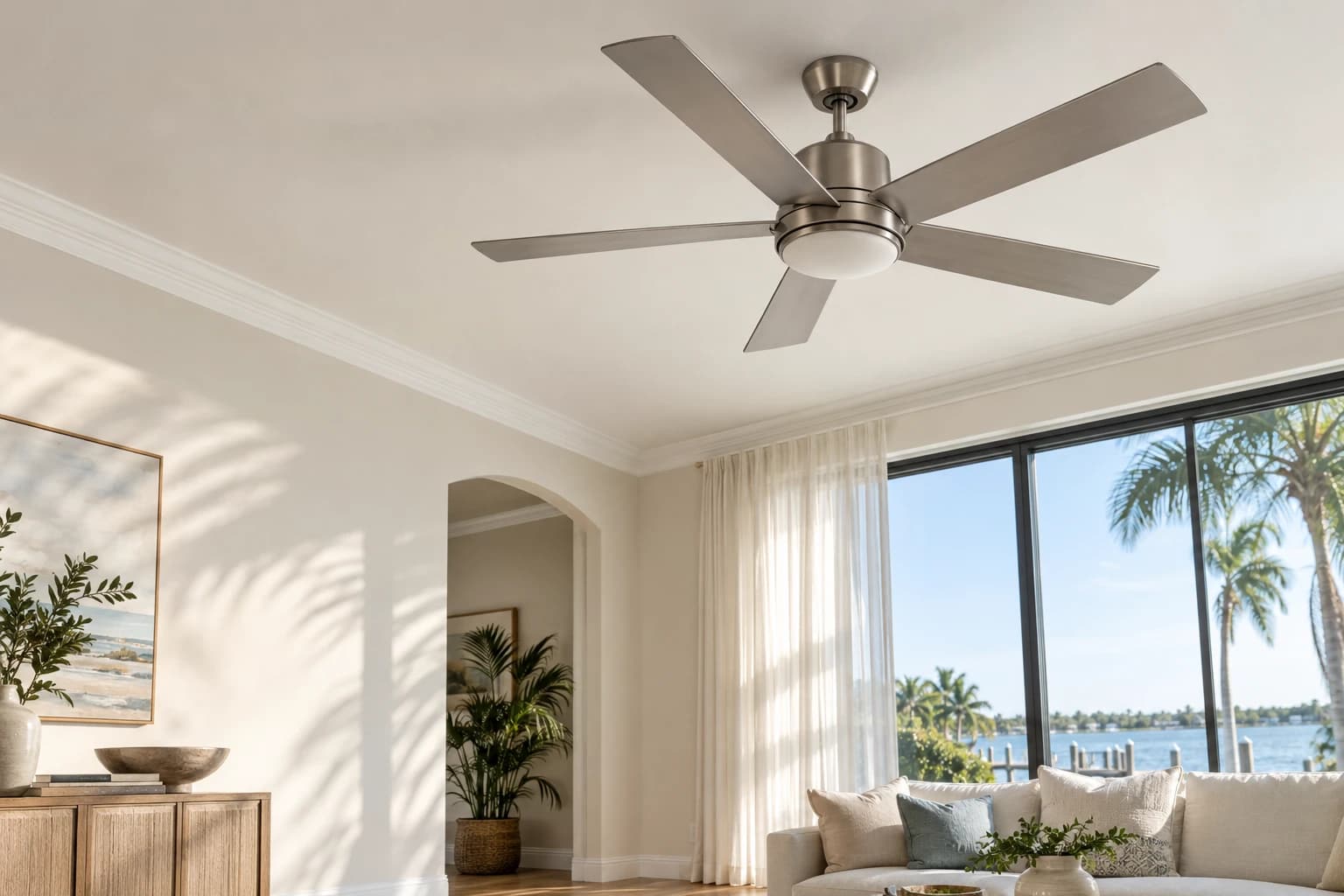 Stationary five-blade ceiling fan in a bright Florida living room with warm neutral walls and soft window light