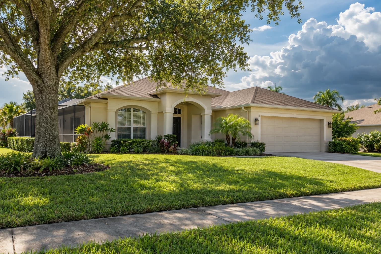 One-story stucco block home on a quiet Brandon street with a screened lanai, live oak shade, and afternoon storm clouds building