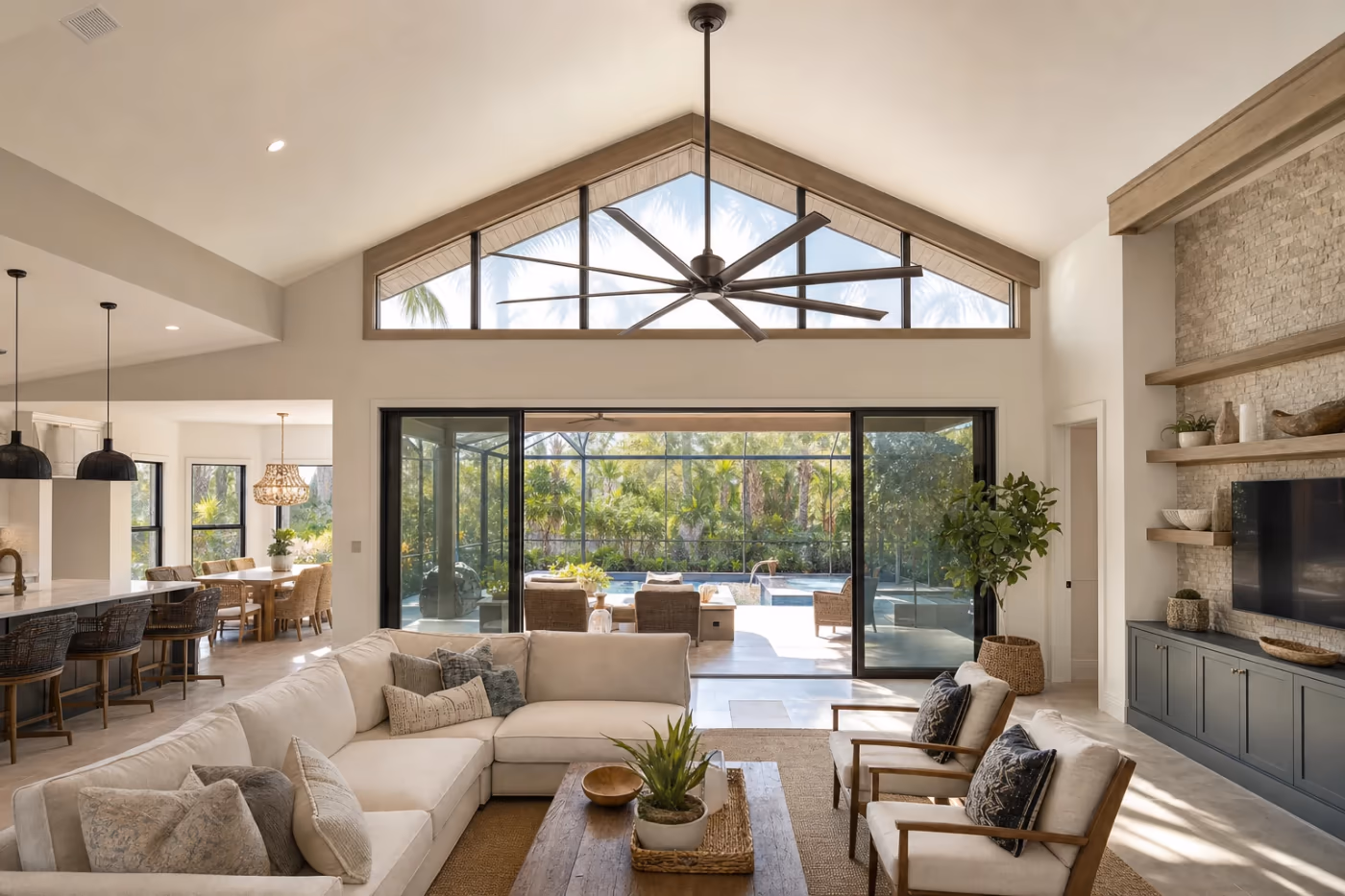 Wide view of a Florida great room with vaulted ceiling and a newly installed ceiling fan above open living space
