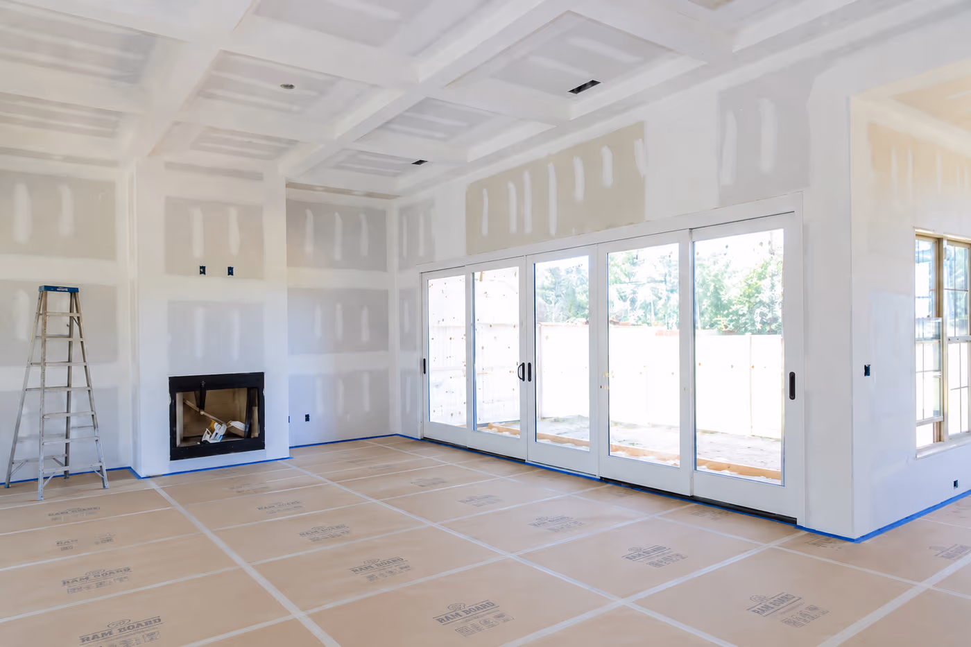 Room with freshly hung drywall, seams taped and ready for finishing