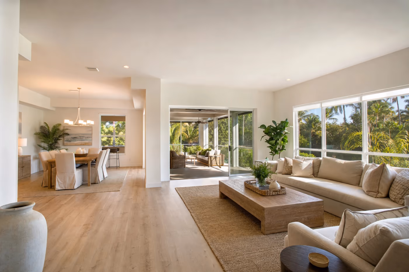 Wide view of a bright Florida open-plan living space with smooth walls and ceiling after drywall repair