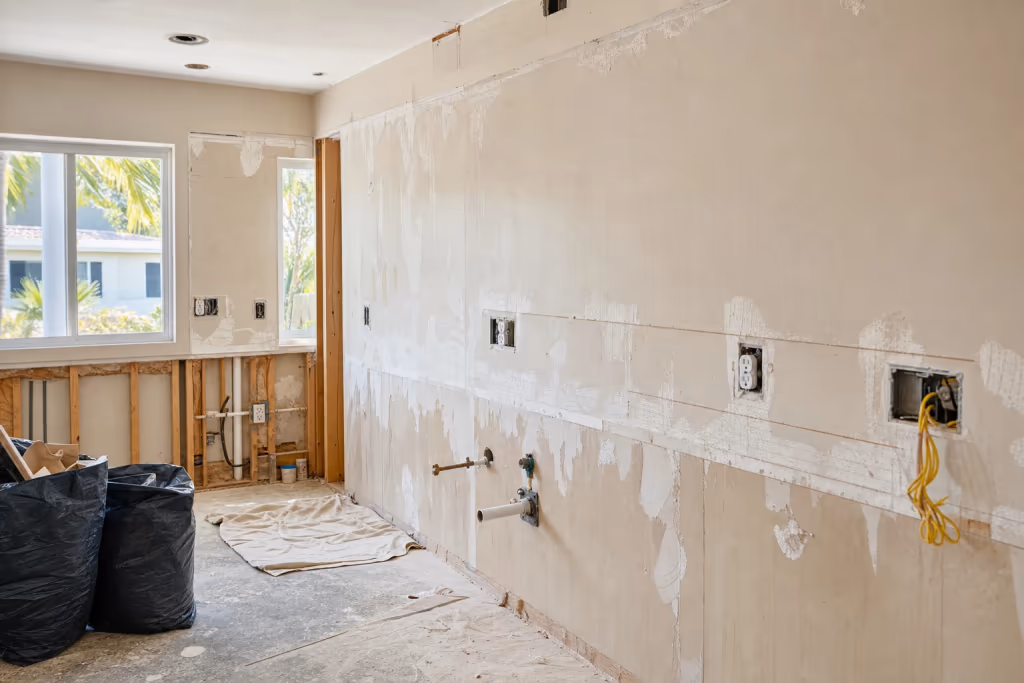 Close-up of a finished luxury Florida kitchen after handyman remodel work, showing flawless cabinetry, tile backsplash, and polished counters in warm natural light