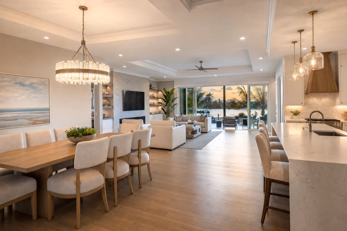 Wide view of a finished Florida living and dining space with new pendant and chandelier lighting