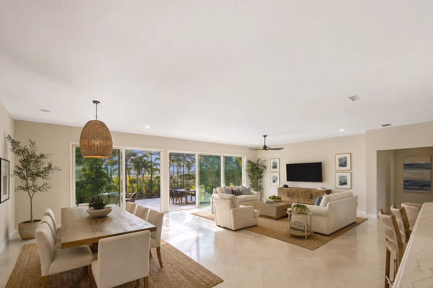 Wide view of a Florida open-plan living and dining space with freshly finished smooth ceilings after popcorn removal