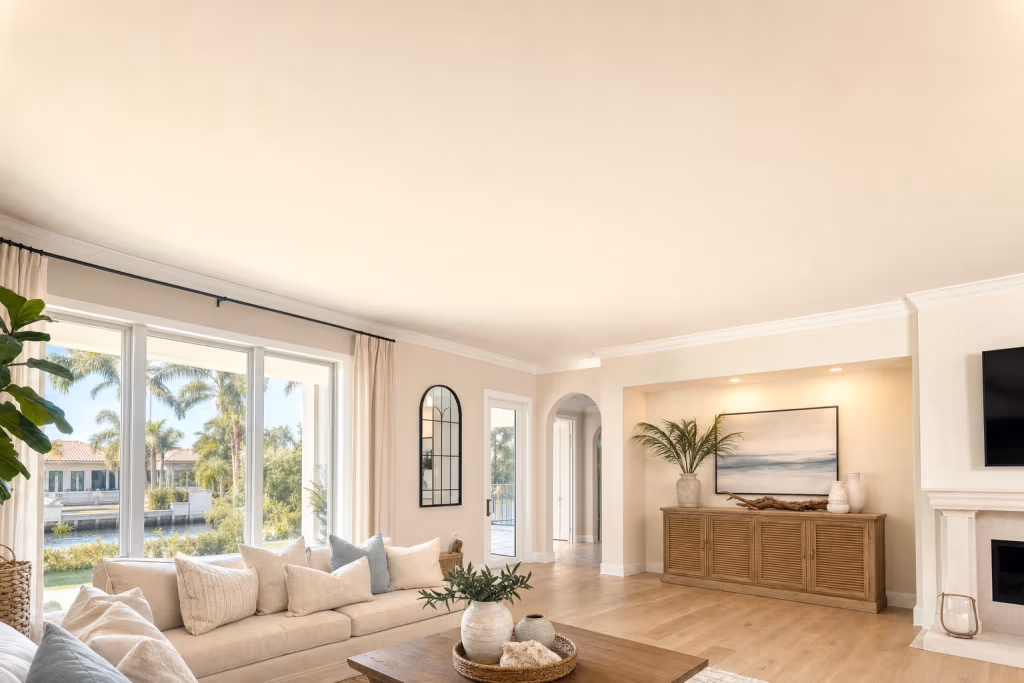 Flawless smooth finished ceiling after popcorn removal in a bright Florida living room, painted and ready