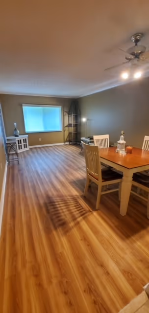 Living room with new plank flooring and freshly painted walls